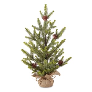 A small artificial Christmas tree with green branches, adorned with pinecones, and wrapped at the base with burlap.
