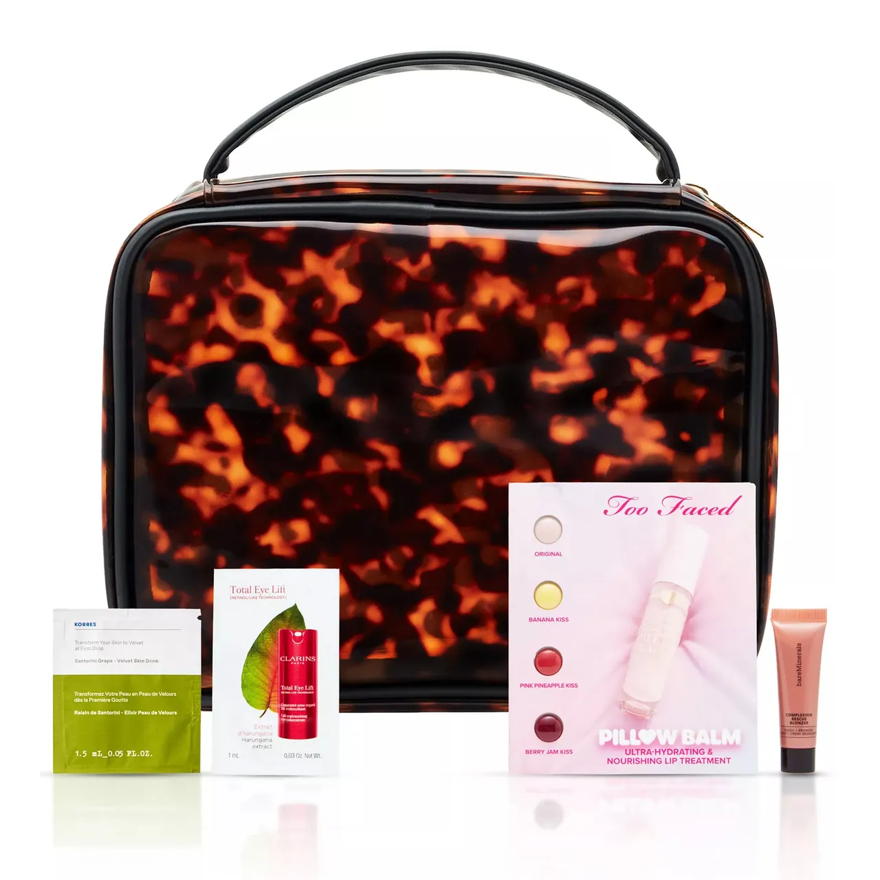 A tortoiseshell-patterned cosmetic bag is shown with samples including Korres face mask, Clarins eye lift, Too Faced lip balm set, and a BareMinerals lip product.