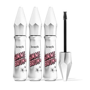 Three silver tubes of Benefit Gimme Brow+, a brow volumizing fiber gel, are shown alongside an opened applicator wand.