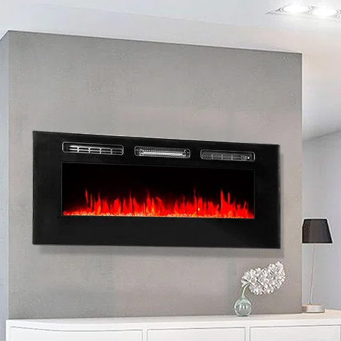 Wall-mounted electric fireplace with a sleek black frame, featuring realistic LED flame effects above a white shelf and a decorative lamp.