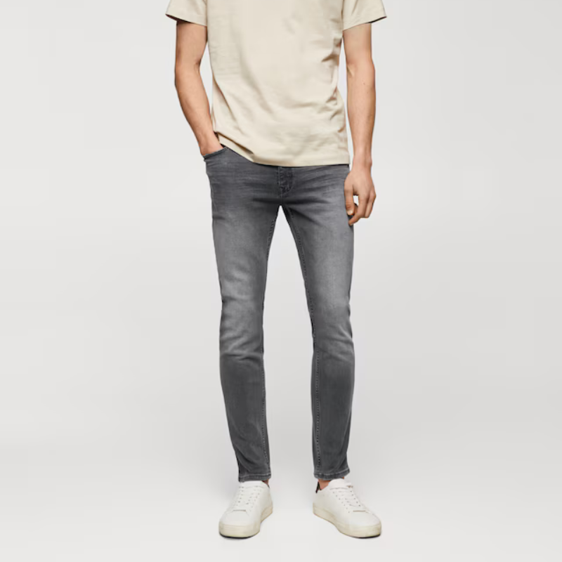 Gray skinny-fit jeans with a five-pocket design and a subtle faded effect on the thighs and knees; paired with a light beige t-shirt and white sneakers.