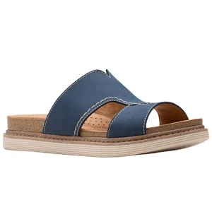 Blue slip-on sandal with wide straps, contrast stitching, and an open toe design, featuring a cushioned cork footbed and a durable sole.