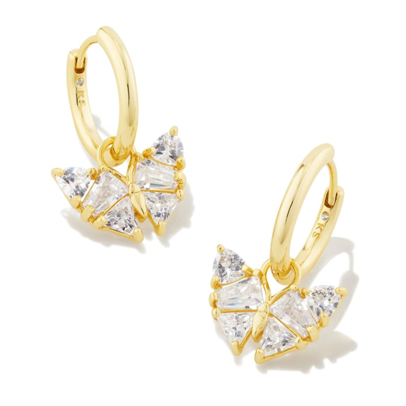 Gold butterfly huggie earrings featuring intricately arranged clear, triangular stones forming a butterfly shape, with a small, embedded stone on the hoop.