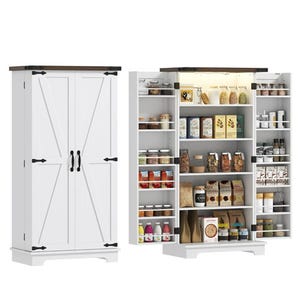 A white pantry cabinet with rustic-style barn doors, featuring multiple shelves filled with food items, jars, and boxes. The interior includes broader central shelves and additional storage on the doors.