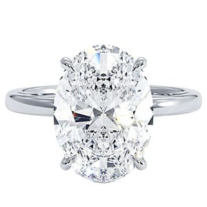A 14k white gold ring featuring a 5-carat lab-grown oval-cut diamond, secured with four prongs. The band is simple and polished.