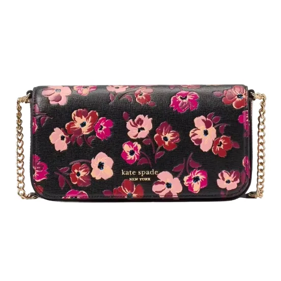 A Kate Spade New York crossbody bag featuring a floral pattern with pink and burgundy flowers on a black background, complemented by a gold chain strap.