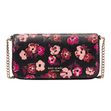 A Kate Spade New York crossbody bag featuring a floral pattern with pink and burgundy flowers on a black background, complemented by a gold chain strap.