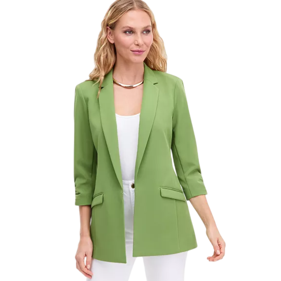 A woman models a light green, three-quarter sleeve blazer over a white top and white pants, complemented by a gold necklace.