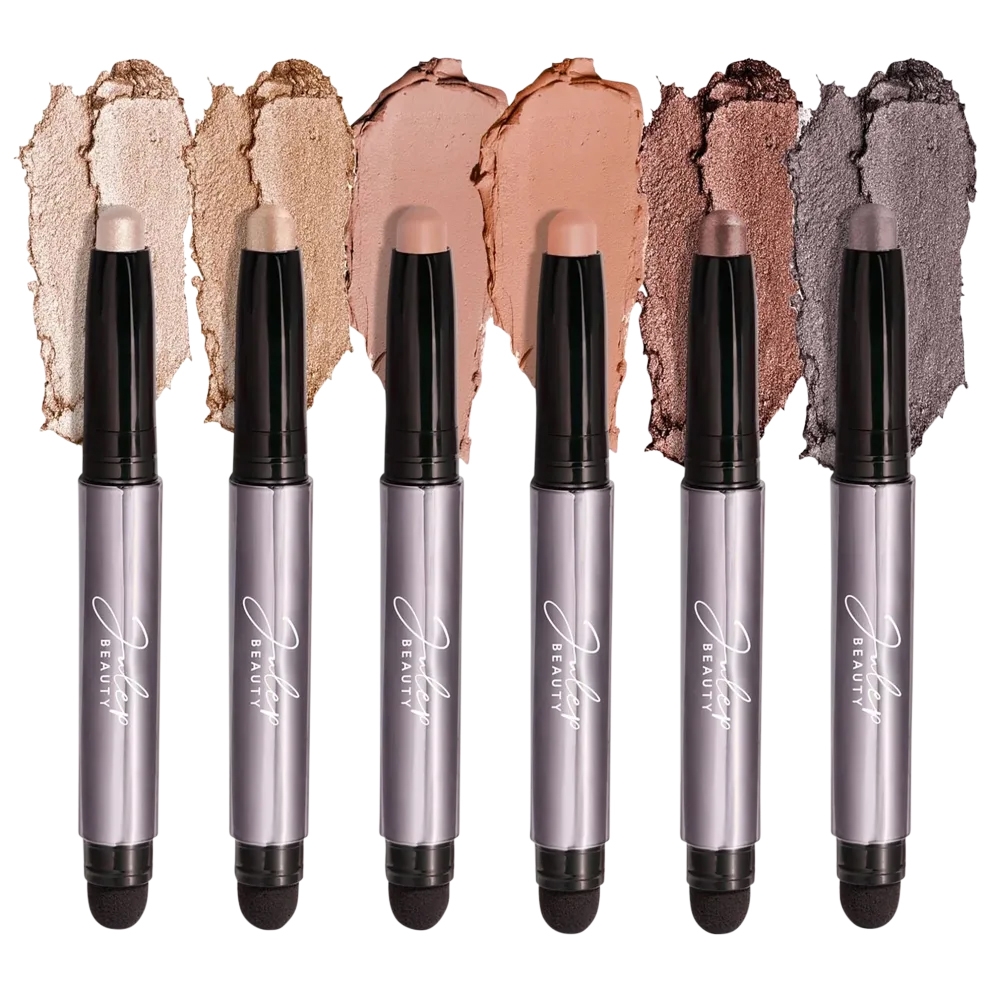Six cream eyeshadow sticks in shades of beige, gold, nude, brown, mauve, and gray are displayed with color swatches.