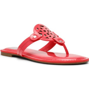 Red thong sandals with a flat sole, featuring a decorative cut-out design on the strap and metal stud accents.