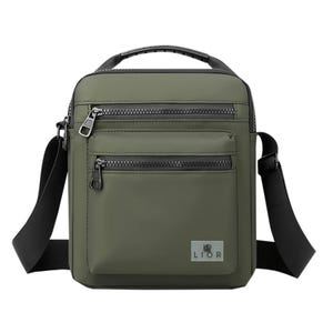 A green crossbody bag with black zippers and a handle, featuring two front zippered pockets and an adjustable black strap. The brand logo \“LIOR\“ is displayed at the bottom.