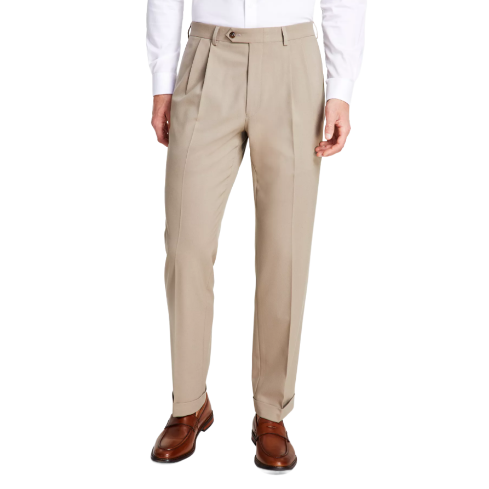 A pair of beige pleated dress pants paired with a white shirt and brown leather loafers.