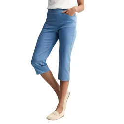 A person is wearing blue cropped pants paired with beige loafers and a white top.