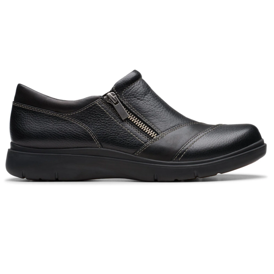Black leather slip-on shoe with side zipper, decorative stitching, and a cushioned sole for comfort.