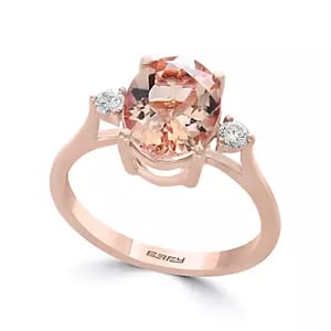A rose gold ring featuring an oval-cut morganite center stone flanked by two round diamonds on either side, designed by Effy.
