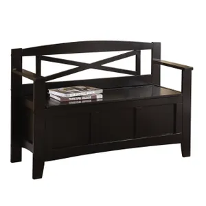 Black wooden entryway storage bench with a backrest featuring an X-shaped design and armrests. The seat lifts up for storage, and three books are placed on top.