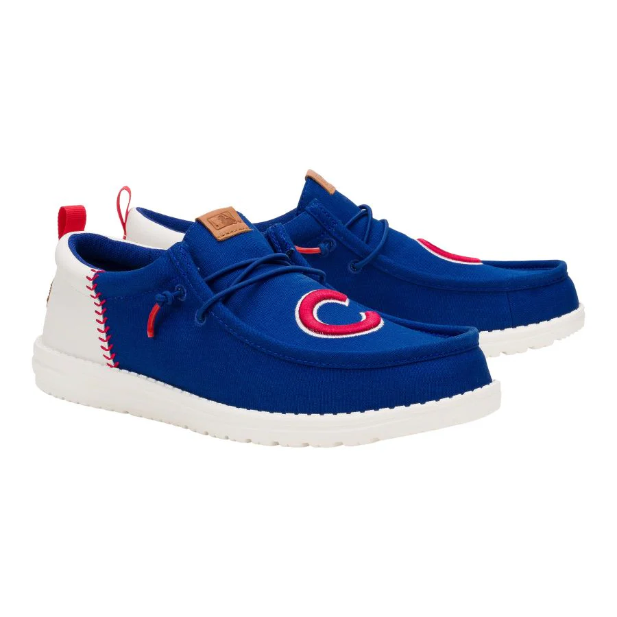 Blue casual shoes with white soles feature a red and white \“C\“ emblem, red stitching, and brown leather-like accents.