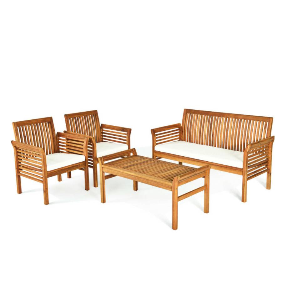 A wooden outdoor furniture set with a bench, two chairs, and a coffee table, all featuring slatted backs and armrests with white cushions.