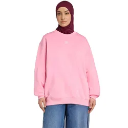 A person is wearing a pink Adidas sweatshirt and blue jeans, along with a dark maroon hijab.