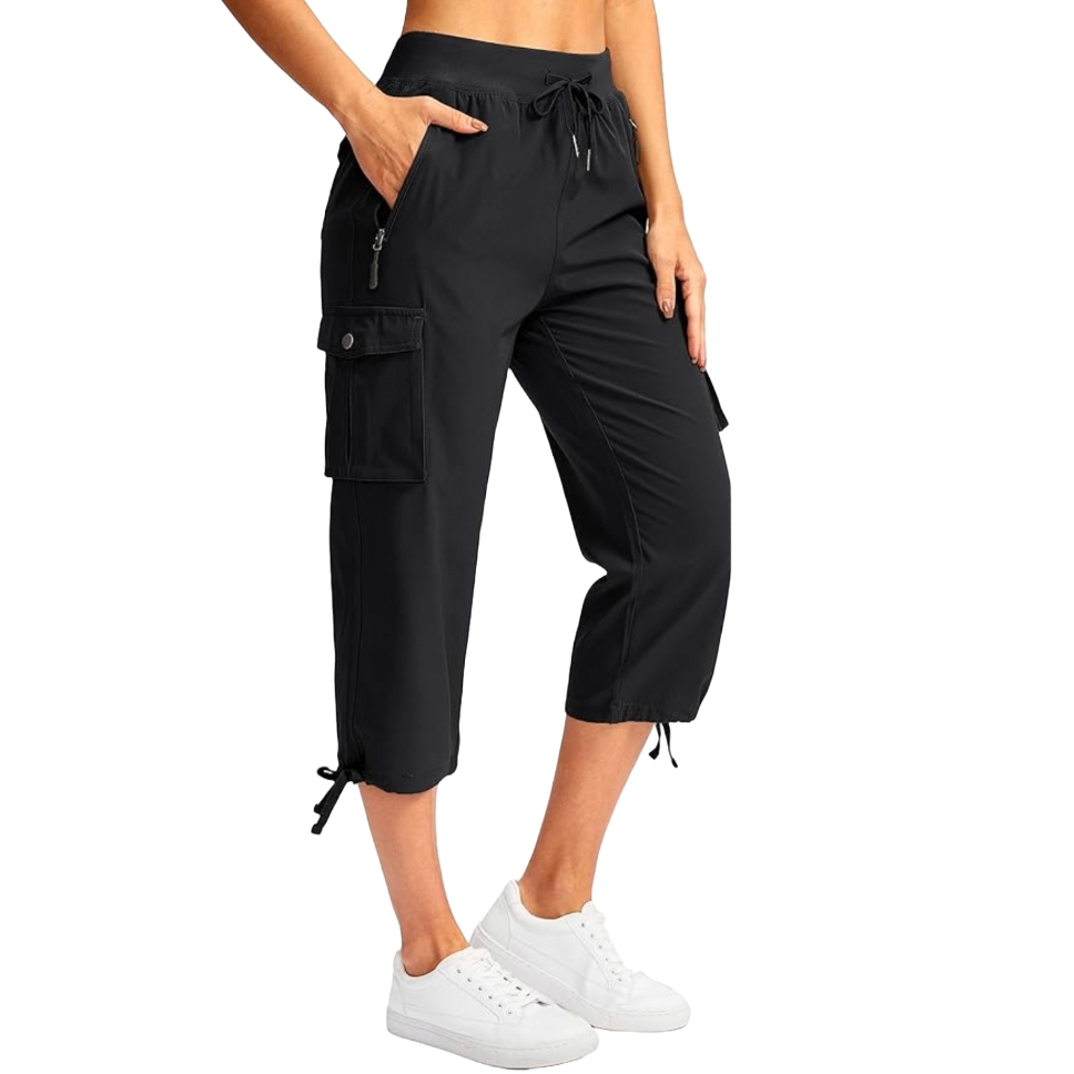 Black capri cargo pants with drawstring waist, side and cargo pockets, and drawstring cuffs, paired with white sneakers.