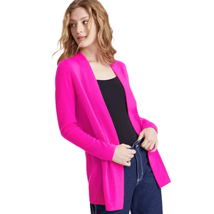 A woman is wearing a bright pink open-front cardigan over a black top and blue jeans.
