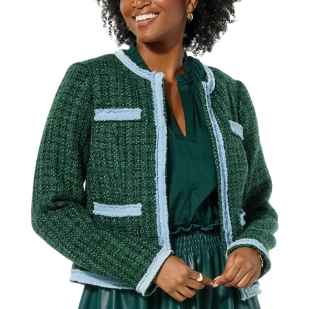 A woman is wearing a green tweed jacket with light blue trim over a green dress.