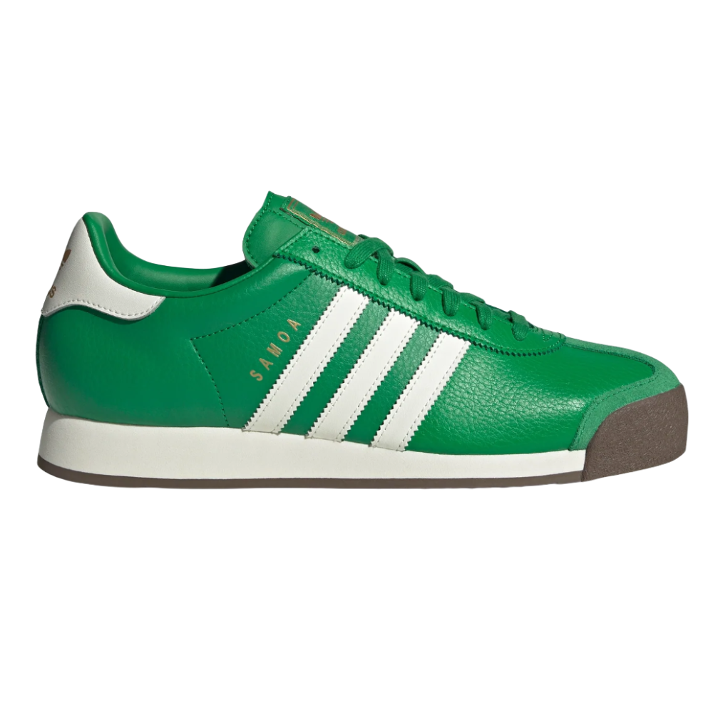 A green Adidas Samoa sneaker featuring white stripes and a brown toe cap with \“SAMOA\“ text in gold on the side.
