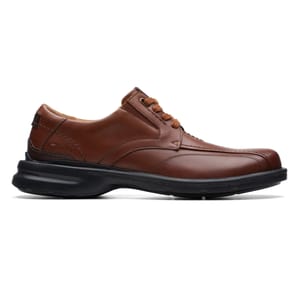 Brown leather shoe with a black sole, featuring a lace-up design and subtle stitching details.