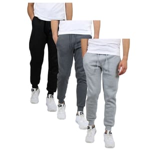 Three pairs of jogger pants in black, dark gray, and light gray, each paired with a white t-shirt and white sneakers.