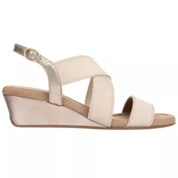 Beige wedge sandal with crisscross elastic straps, ankle strap with gold buckle, and a comfortable cushioned sole.