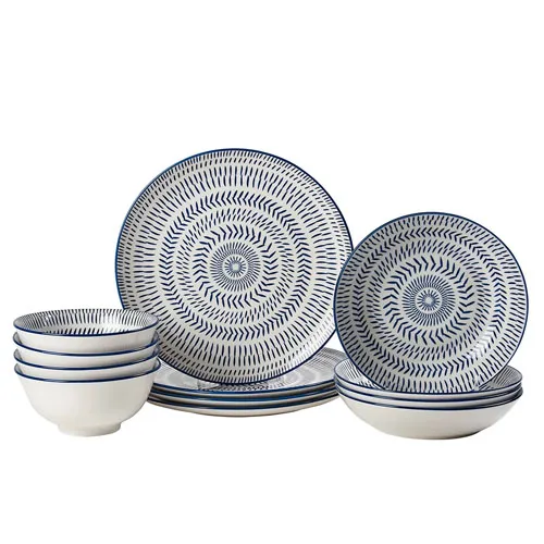 A set of blue and white patterned dinnerware, including plates, bowls, and salad plates.