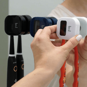 Toothbrush sanitizers with the brand \“bril\“ attached to toothbrushes, providing a hygienic solution for storing toothbrush heads.