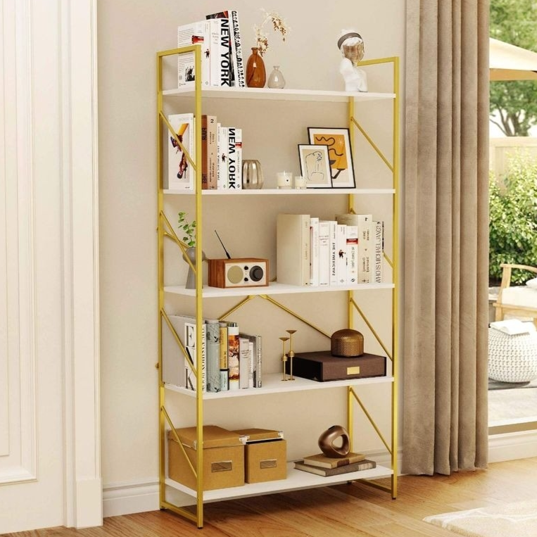 A white and gold bookshelf is adorned with books, decorative items, and storage boxes, placed beside a floor-length curtain in a room with wooden flooring, leading to an outdoor patio.