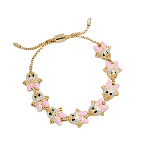 A gold-toned bracelet featuring multiple charms of a cartoon character's face with pink accents and a bow, designed with an adjustable sliding mechanism.