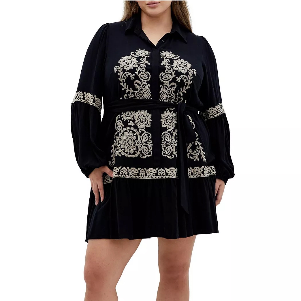 A black dress with button-up detailing and intricate white floral embroidery, featuring long puffed sleeves and a waist tie belt.