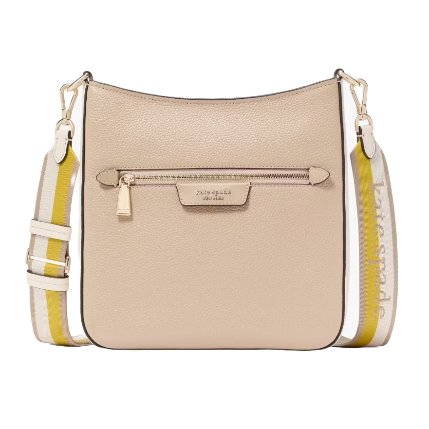 A beige leather crossbody bag with a front zipper pocket and a detachable striped strap featuring the \“kate spade new york\“ logo.