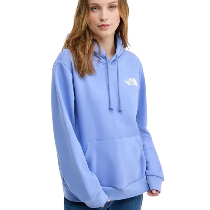 A woman is wearing a light blue The North Face hoodie with a front pocket and drawstrings, paired with blue jeans.