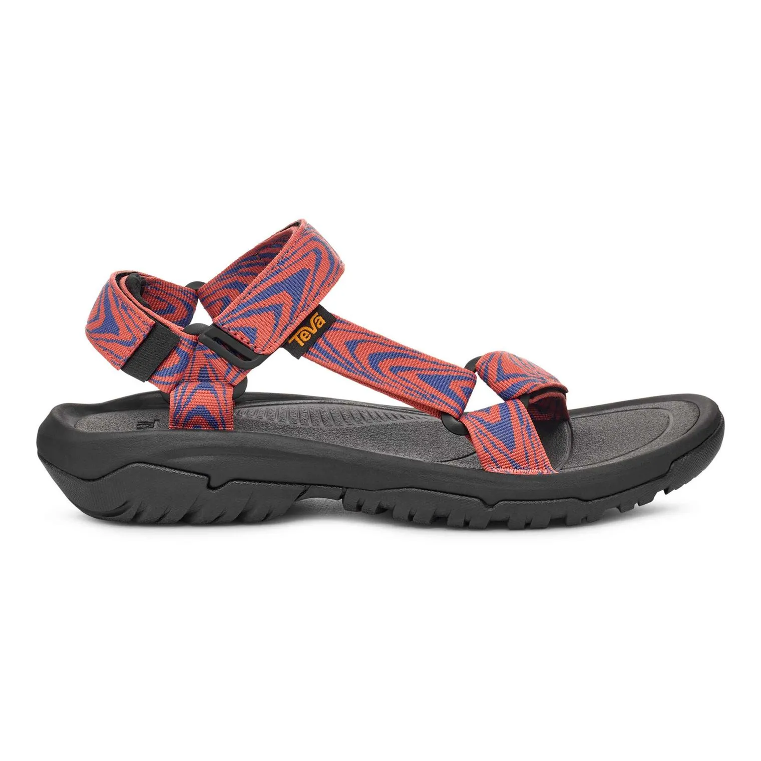 A sporty sandal with a patterned, adjustable strap and a rugged black sole designed for outdoor wear.