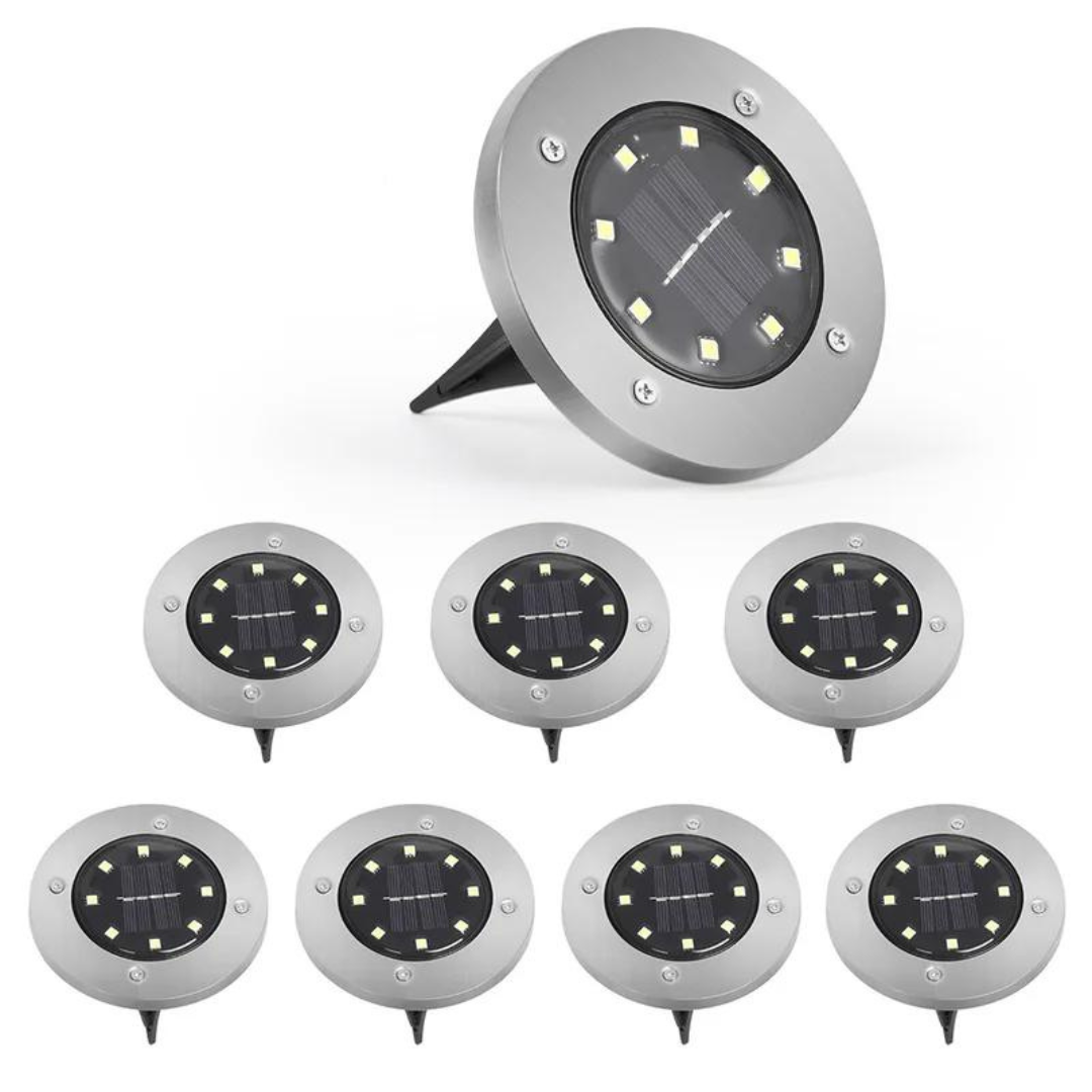 Eight solar-powered LED ground lights with a circular design and metallic finish.