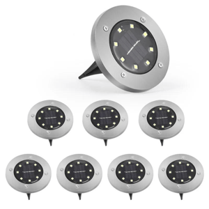 Eight solar-powered LED ground lights with a circular design and metallic finish.
