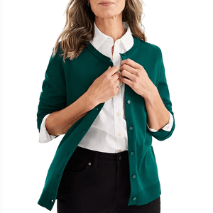 A green button-up cardigan with long sleeves and a ribbed hemline, worn over a white collared shirt.