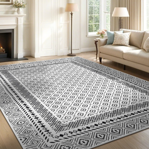 A living room features a white and black geometric patterned area rug on a wooden floor, accompanied by a beige sofa with pillows, a fireplace, and decorative elements like a floor lamp and artwork.