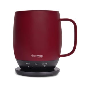The Nextmug Temperature Controlled Mug is a sleek, red mug with a handle, designed to keep beverages at specific temperatures (Warm, Hot, Piping) as indicated on its base.