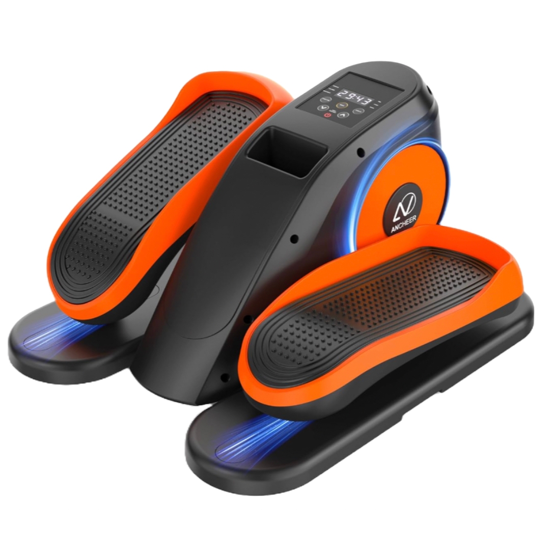 An under-desk elliptical with orange and black design, featuring textured foot pedals, a digital display, and blue LED lighting.