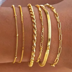 A set of five 14K gold bracelets, each with a unique chain design: two with sleek thin strings, one with a twisted rope style, one flat and textured, and one with elongated links. They are waterproof and designed to be worn stacked.