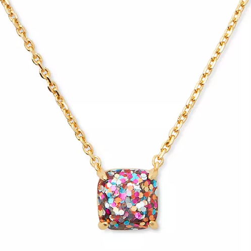 A gold-tone chain necklace with a square pendant featuring multicolored glittery details.