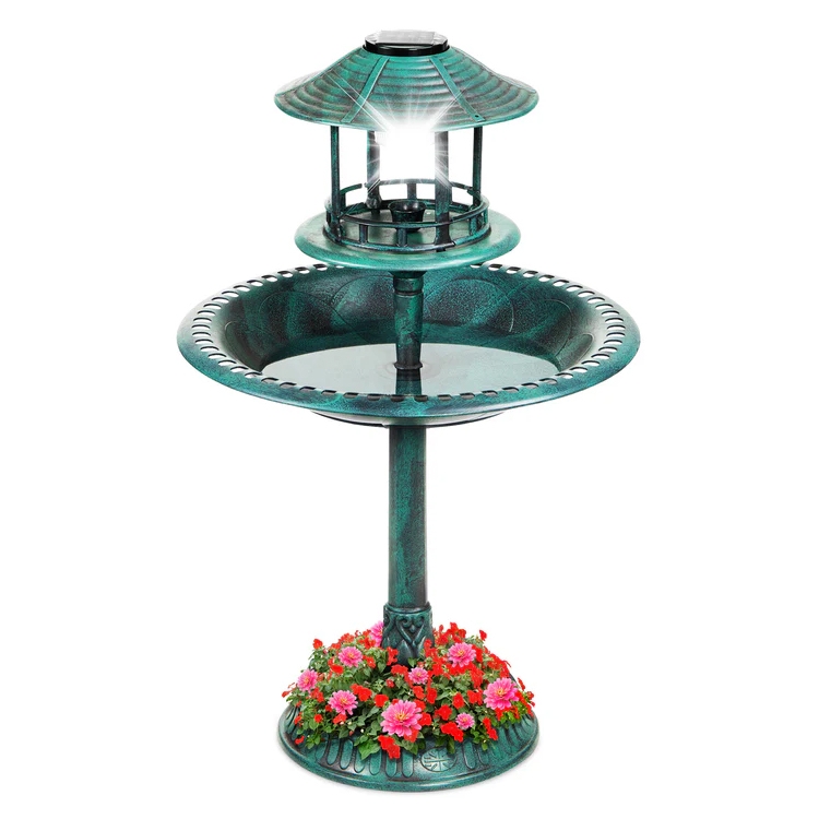 A teal-colored birdbath with a solar-powered lantern on top, featuring a floral design around the base.