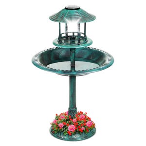 A teal-colored birdbath with a solar-powered lantern on top, featuring a floral design around the base.