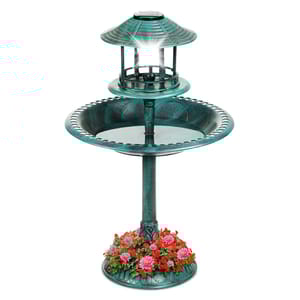 A teal-colored birdbath with a solar-powered lantern on top, featuring a floral design around the base.