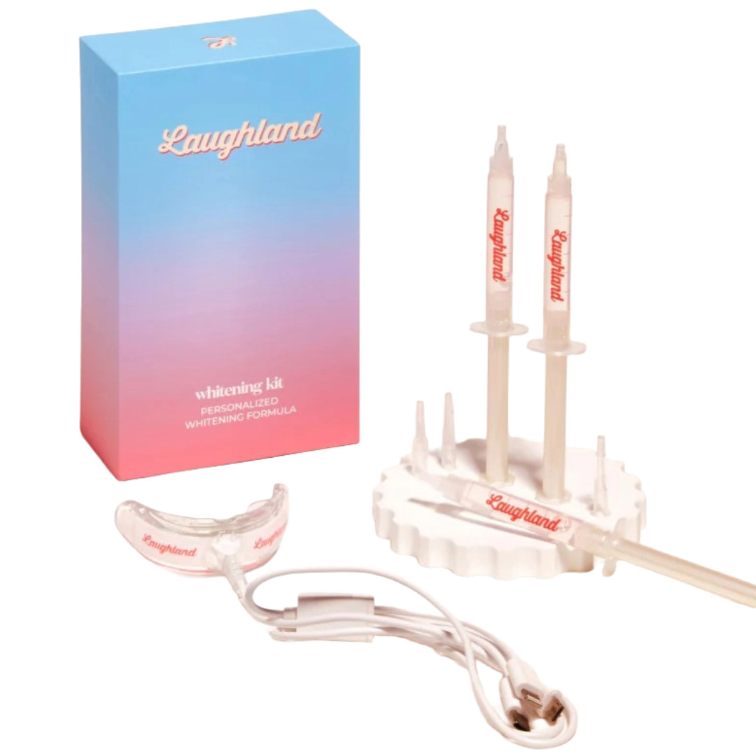 Laughland teeth whitening kit with a gradient blue and pink box, two whitening gel syringes, a mouth tray, and a USB charging cable.